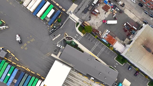 Aerial shot flying forward over a large industrial park with warehouses, distribution centers and rail road in Oregon.