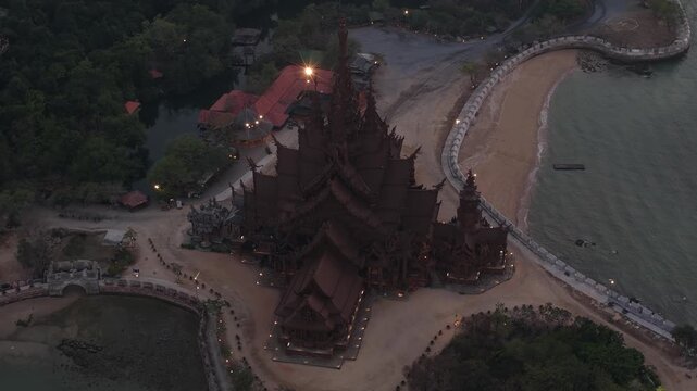 Sanctuary of truth wooden temple descending aerial view at dusk in pattaya thailand