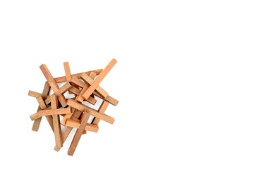 Heap of wooden crosses on a white background. Copy space above and to the right side.