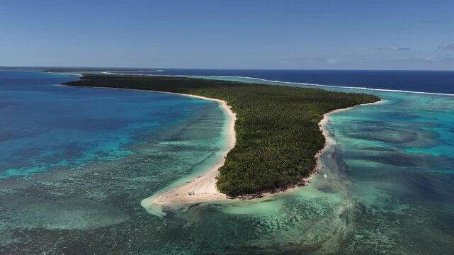 Drone fly around the tiny island of Eua, Kingdom of Tonga, capturing its full perimeter, lush palms, rugged coastline, and endless Pacific waters from a sweeping aerial perspective.