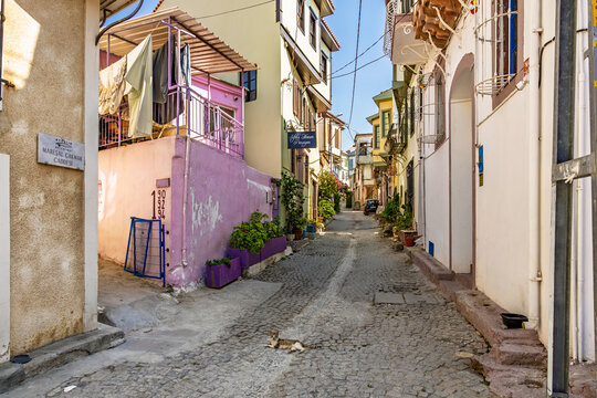 Quaint cobblestone street in sunny european village with colorful buildings. August 3, 2025, Ayvalik, Turkey