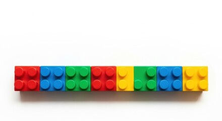 Fototapeta premium Colorful Lego Bricks Arranged in a Row on White Background.