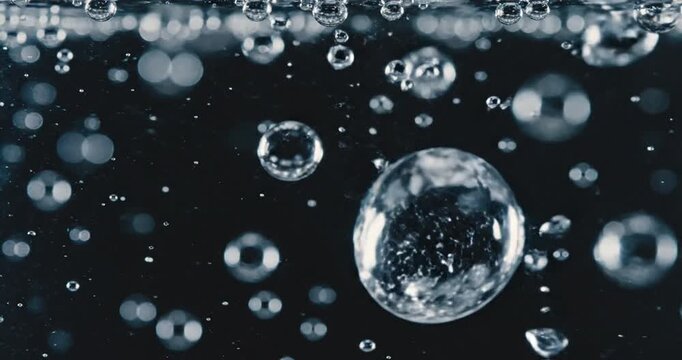 Bubbles Rising in Dark Water with Light Reflections Creating a Mystical Atmosphere