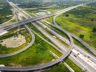 Drone shot a large highway interchange crossing over green farmlands in Thailand © Kaikoro