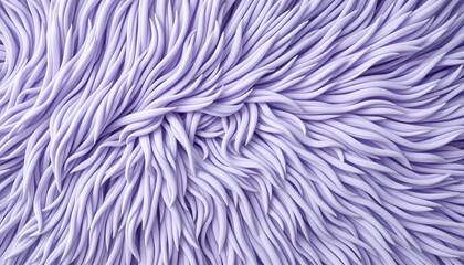 Fototapeta premium A textured surface that resembles fur or faux fur in purple hues, presented against a neutral gray background with a horizontal strip of another fabric in light purple.