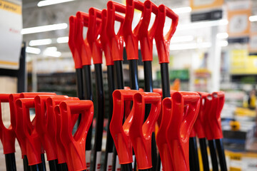 Red plastic shovel handles . Close up © alan