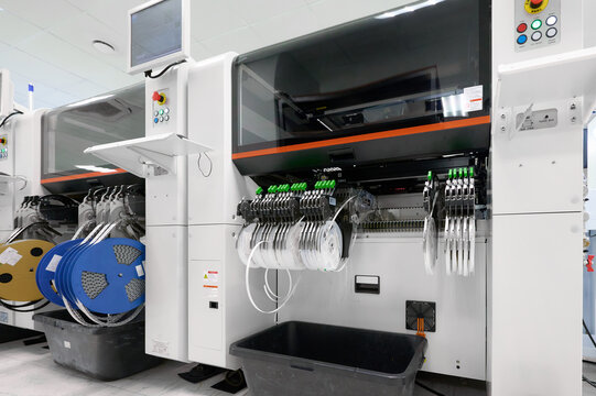 SMT pick-and-place machine with tape feeders in an electronics assembly facility during production
