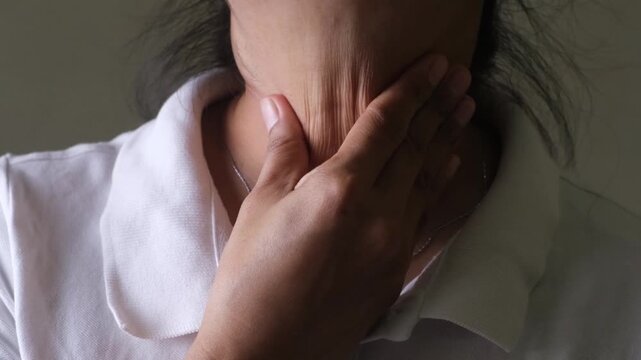 asian woman having a sore throat