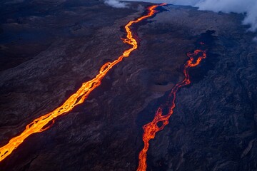 Molten lava stream flowing from volcanic vent during night eruption © yannis