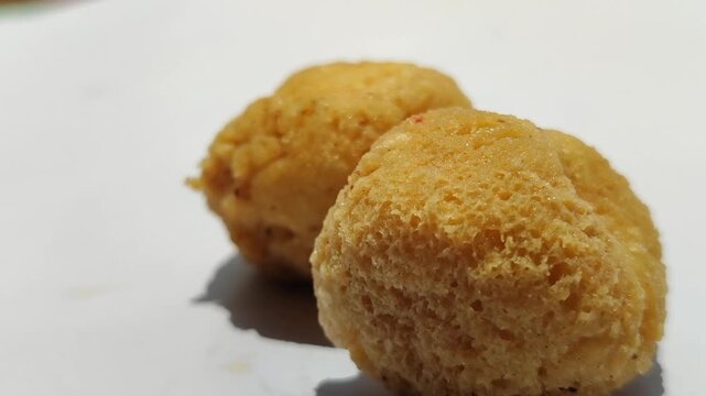 Tahu bulat, popular Indonesian street snack made from fried tofu balls, crispy outside and soft inside, freshly served as delicious local culinary food.