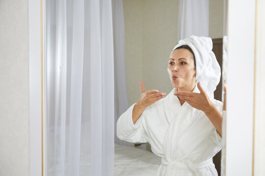 Young woman doing facial gymnastics self massage and rejuvenating exercises. Face building for skin and muscles lifting