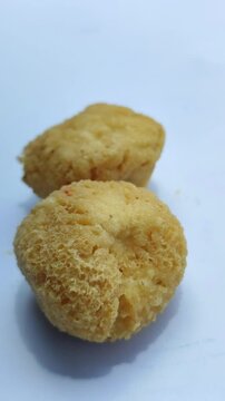 Tahu bulat, popular Indonesian street snack made from fried tofu balls, crispy outside and soft inside, freshly served as delicious local culinary food.