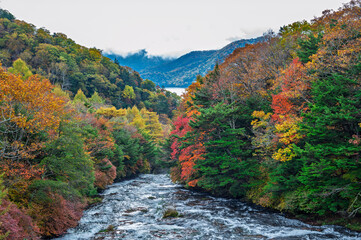 Ryuzu Waterfall or Ryuzu Cascades with autumn background is one of Landmark in Nikko to see autumn colors Nikko, Tochigi, Japan