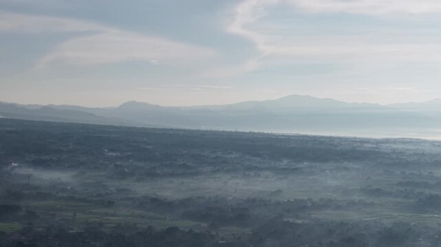 Misty Valley Landscape With Layers of Mountains and Soft Morning Fog Over Rural Plains
