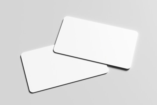 Mockup of two blank white business cards with rounded corners on a minimalist gray background