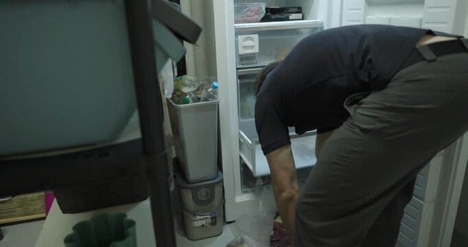 Realistic scene of a person placing vacuum-sealed meat into a freezer, representing food storage, freezing, and home meal preparation.