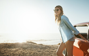 Happy, woman and outdoor with car, beach and relax on summer vacation, tourism or sunshine in nature. Sea, scenery and person with vehicle on road trip, space and fresh air on drive with transport