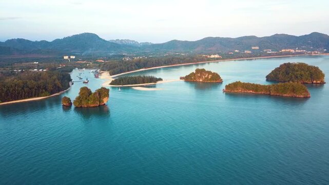 Stunning aerial wide shot of Nopparat Thara Beach featuring turquoise waters and limestone karst islands during a peaceful morning. Ideal for travel documentaries and tropical vacation promos.