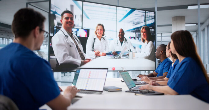 Doctors Participating In Webinar On Projector Screen