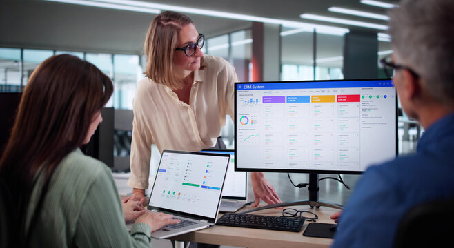 Senior Business Leader Trains Staff Using CRM Software