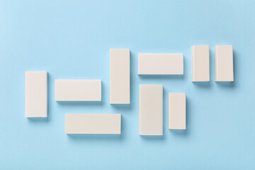 Composition with white rubber erasers on blue background