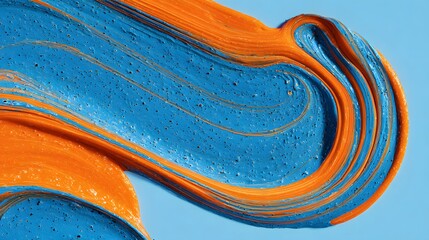 Obraz premium Vibrant Blue and Orange Paint Swirls Creating an Abstract Artistic Pattern.