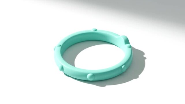 Teal silicone teething ring with nodules on white background