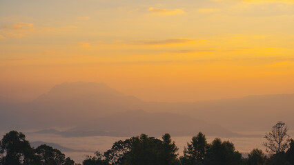 Obraz premium sunrise with moving of cloud and clear sky and layer of mountain