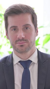 Young Businessman with Finger on Lips, Please be Quiet, vertical video