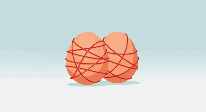 Two orange eggs with red string intricately wrapped around them