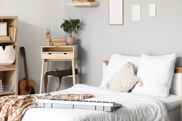Interior of teenager's room with bed, synthesizer and table