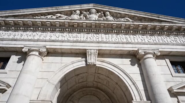 Grand classical stone building facade with columns and ornate carvings