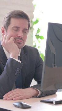 Tired Young Businessman Sleeping at Work, vertical video