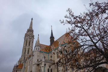 Fototapeta premium Mathias church or the Church of Our Lady of Buda Castle and its tower, fisherman's bastion in Castle hill and district on a beautiful winter Christmas season day, Budapest, Hungary 