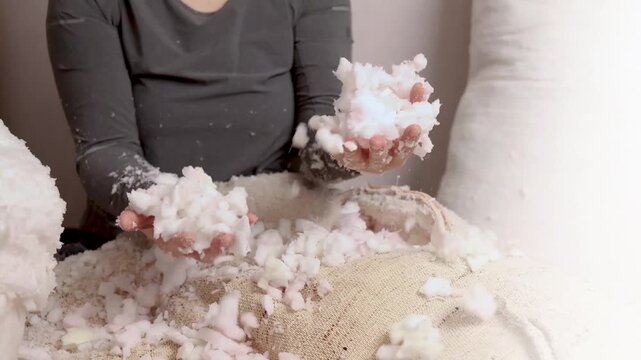 Filler for pillows, furniture, armchair, sofa. Foam crumb. 4k Footage