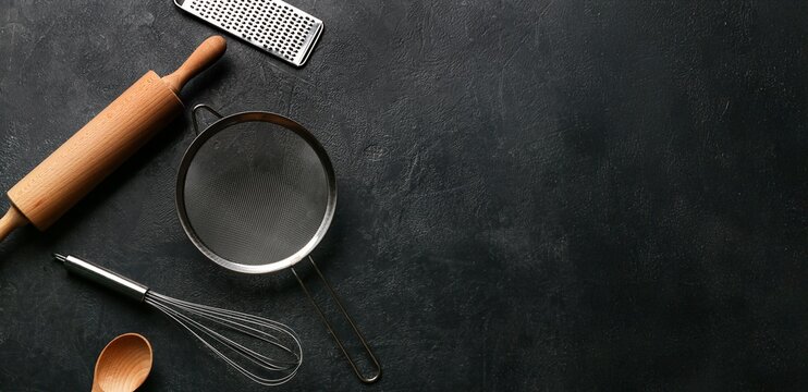 Set of kitchen utensils on dark grunge background with space for text