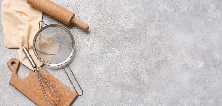 Set of kitchen utensils on grey grunge background with space for text