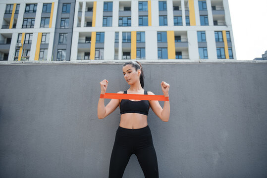 Woman Exercising With Resistance Band
