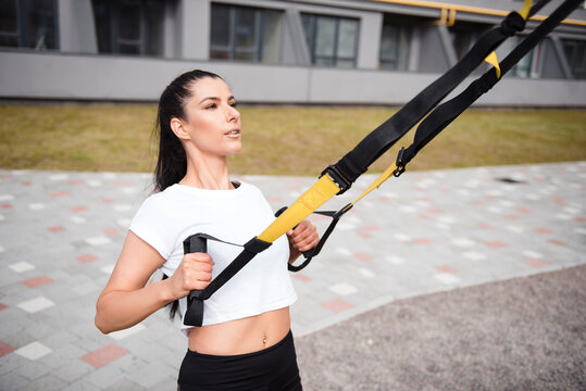 Fitness brunette woman in black leggings training outdoor