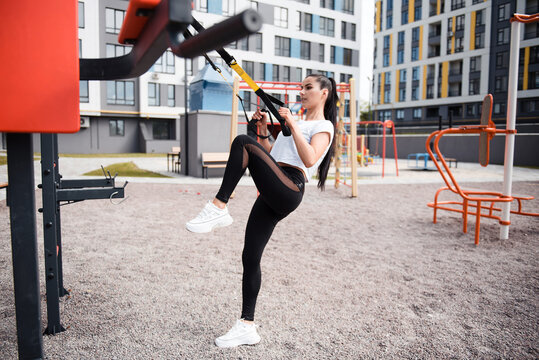 Fitness brunette woman in black leggings training outdoor