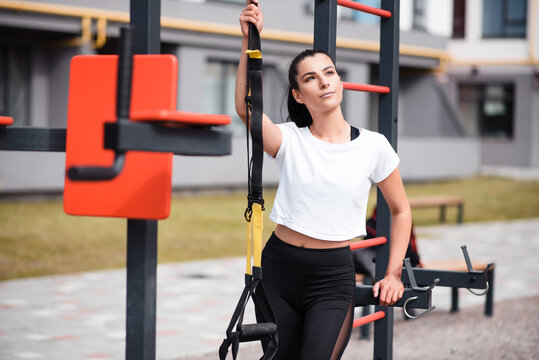 Fitness brunette woman in black leggings training outdoor