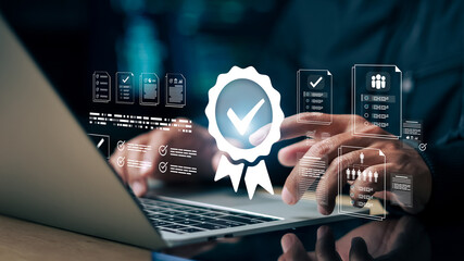Businessman using laptop with digital checklist and quality badge icon. Concept of quality...