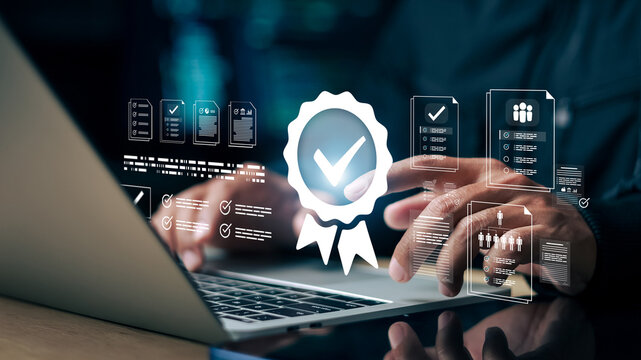 Businessman using laptop with digital checklist and quality badge icon. Concept of quality assurance, compliance audit, certification approval, document management and business standard control.