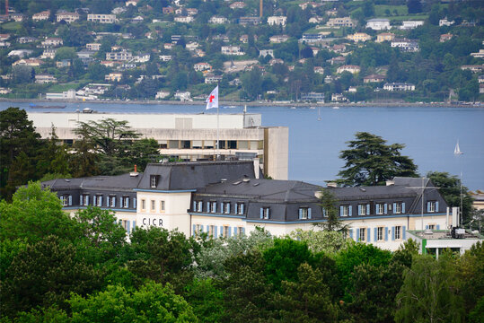 Geneva, Switzerland, Europe : International Red Cross and Red Crescent Movement, Buildings of Headquarters of International Committee of Red Cross, ICRC flapping  flag, Lake Geneva in background
