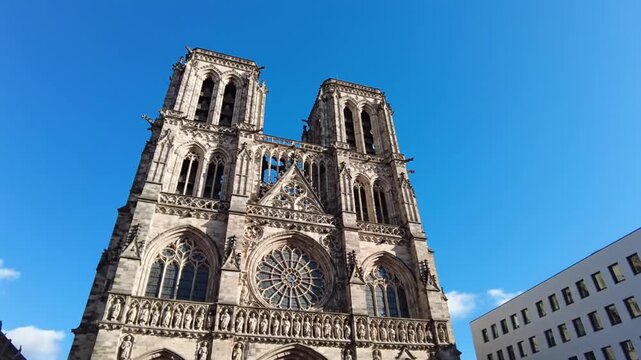 French Gothic cathedral with modern building under blue sky