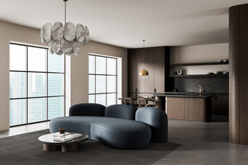 Modern interior design with curved blue sofa, wooden kitchen, and elegant pendant lighting in a...