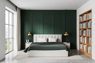 Modern bedroom interior with green accent wall, cozy bed, wooden bookshelf, and natural light from...
