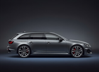 Fototapeta premium Luxury silver station wagon parked in dark studio background