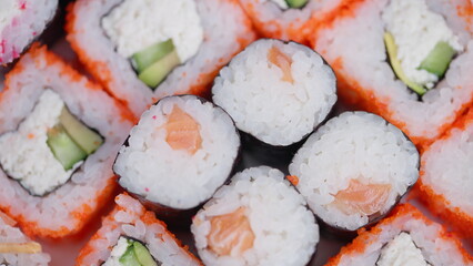 Colorful sushi arranged with crisp vegetables and shiny fish. An assortment of vivid sushi dishes featuring crisp vegetables and glossy fish toppings for presentation © beholdereye