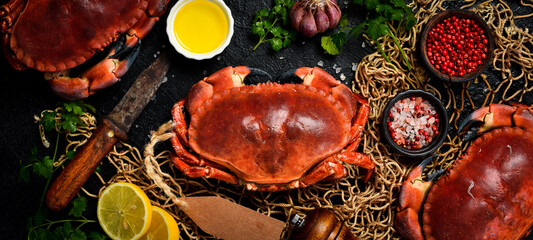 Delicious boiled large crabs with claws, served with lemon, salt and spices. A great appetizer with beer or wine. © Yaruniv-Studio
